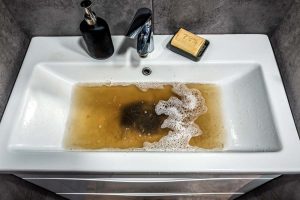 Clogged white sink in bathroom Boston, MA